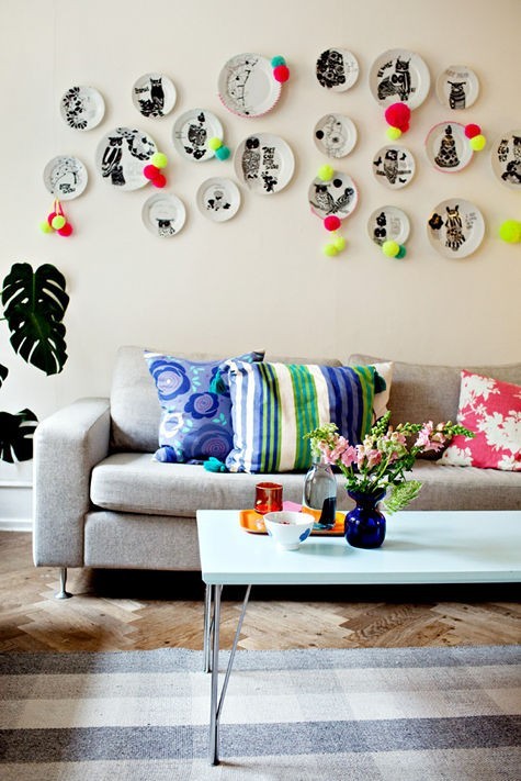 colorful living room with plates on the wall