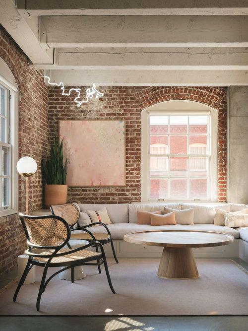 modern living room with sectional sofa brick walls and floor to ceiling white Double-Hung Windows With Munitions pearl loft