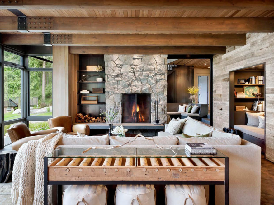 rustic ocean home large living room with stone fireplace and large windows